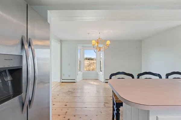 a view of a dining room with furniture and chandelier