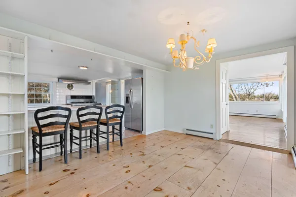 a view of a dining room with furniture and wooden floor