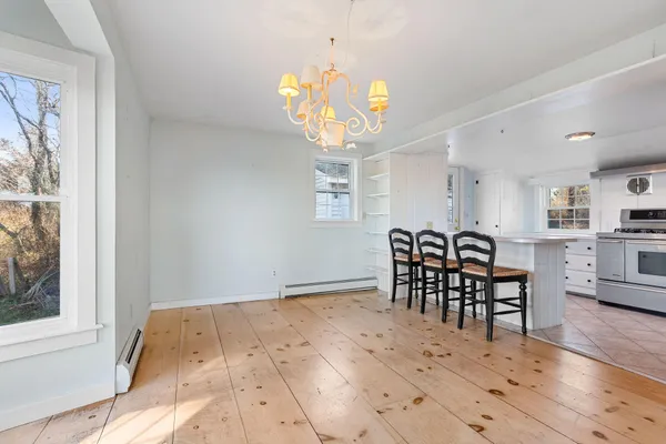 a view of a a dining room with furniture and window