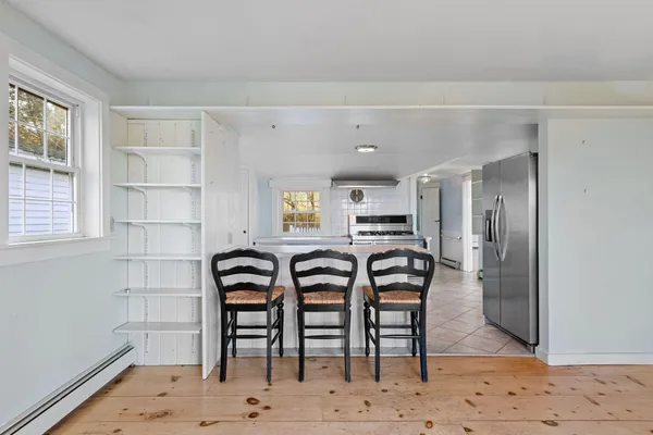 a view of a big room with wooden floor and windows