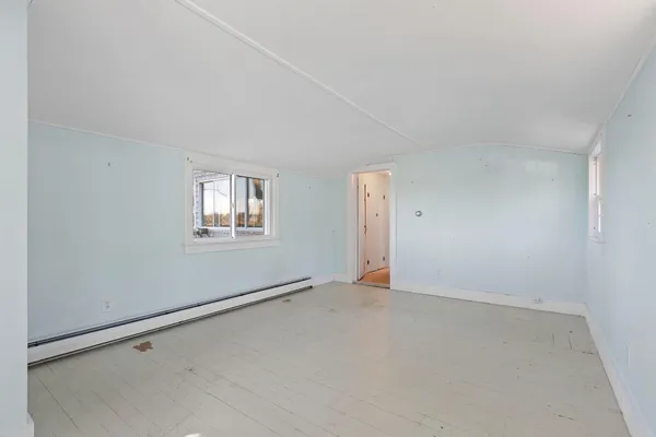 a bathroom with a granite countertop sink a toilet a mirror and a window