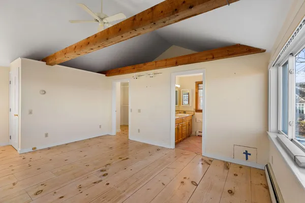a bathroom with a granite countertop sink vanity mirror bathtub and toilet