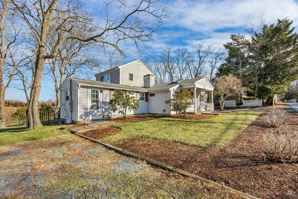 a view of a house with a yard and sitting area