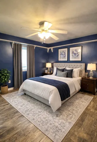 a bedroom with a large bed and a chandelier