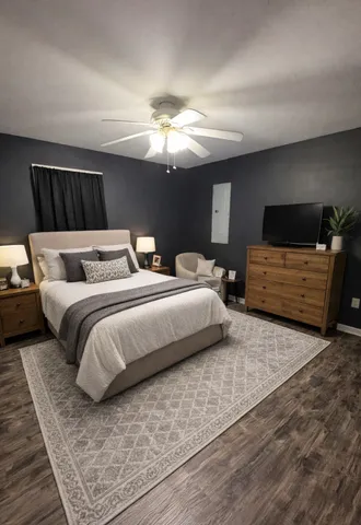 a bedroom with a bed and a chandelier