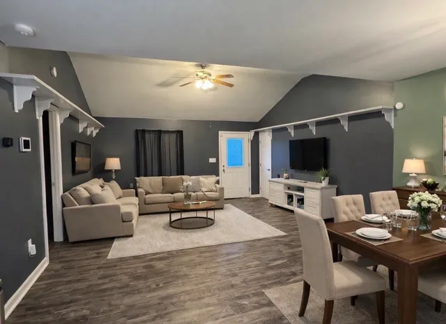 a living room with furniture and a flat screen tv