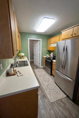 a kitchen with a sink appliances and cabinets