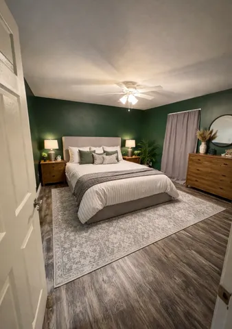 a bedroom with a bed and a chandelier