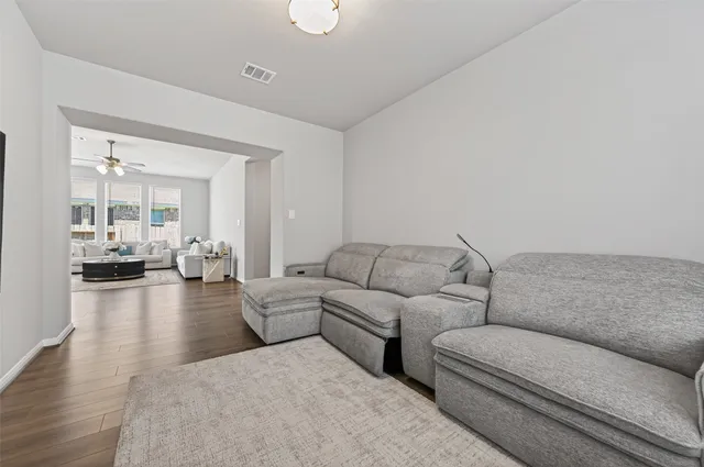 a blue bed sitting in a bedroom next to a window
