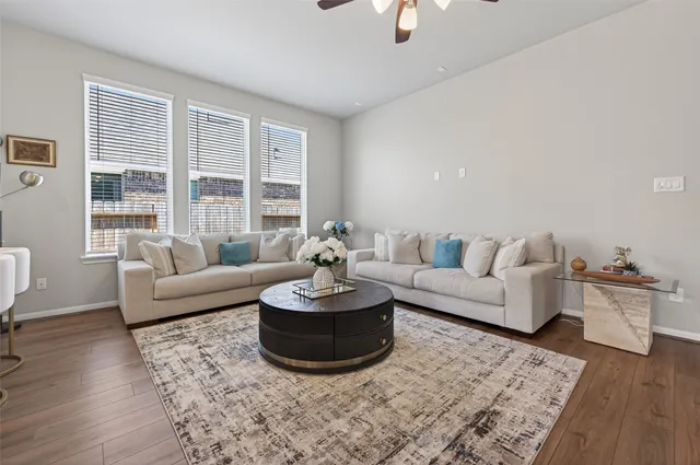 a living room with furniture and a chandelier