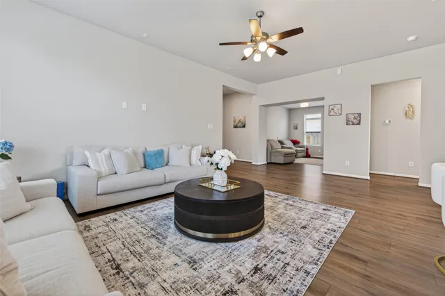 a kitchen with stainless steel appliances granite countertop a refrigerator a sink dishwasher a kitchen island with wooden cabinets and floor