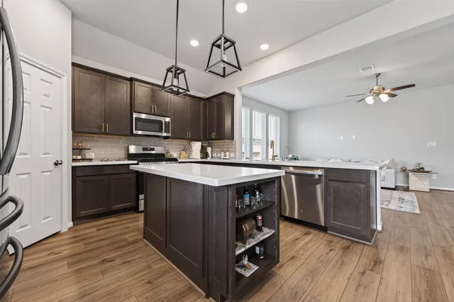 a dining room with furniture a chandelier and wooden floor