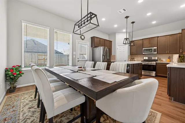 a view of a dining room with furniture window and wooden floor