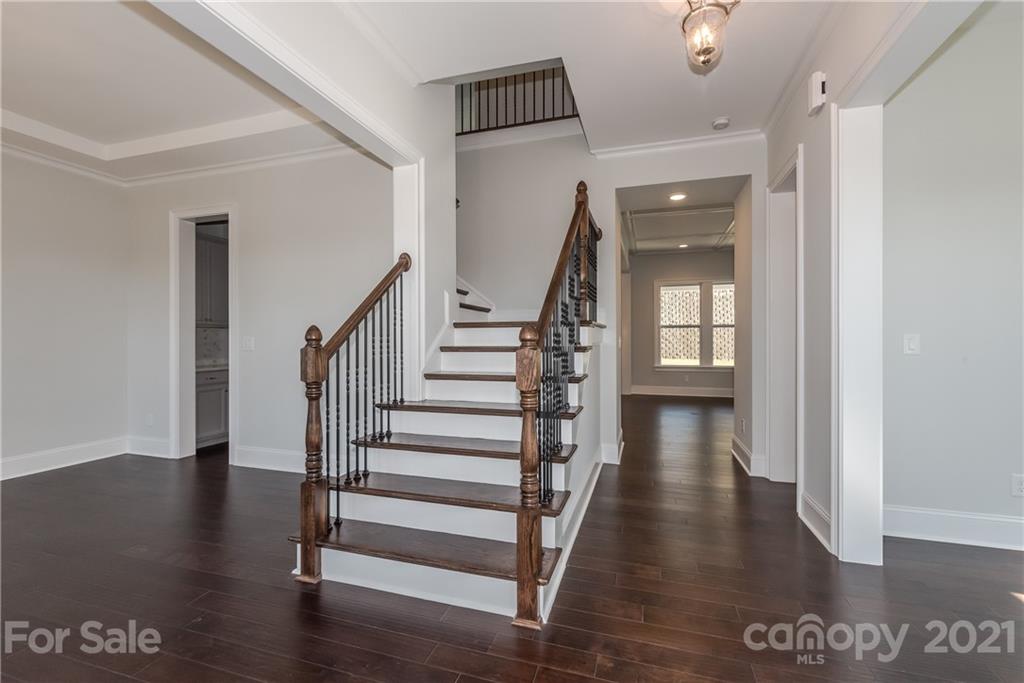 4006 Oarman Court, Unit 440 Fort Mill, SC 29708 - Photo 2 of 15 a view of a hallway with wooden floor and stairs
