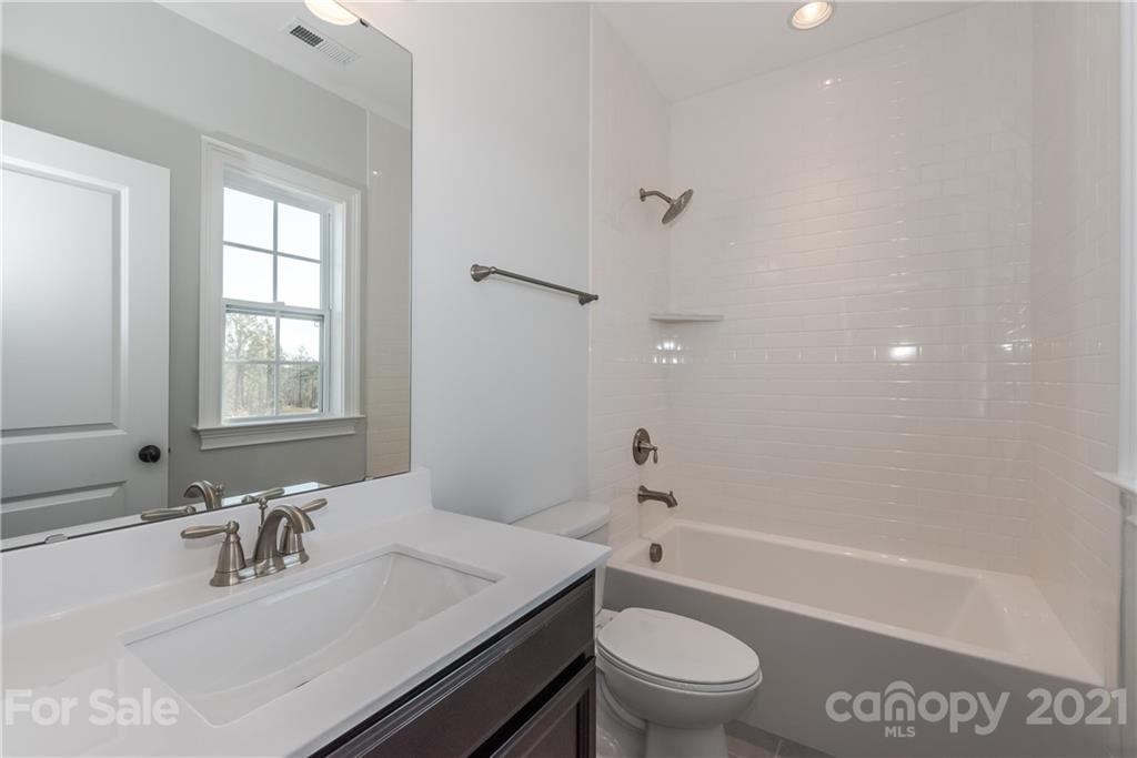 4006 Oarman Court, Unit 440 Fort Mill, SC 29708 - Photo 12 of 15 a bathroom with a sink a toilet and a bathtub
