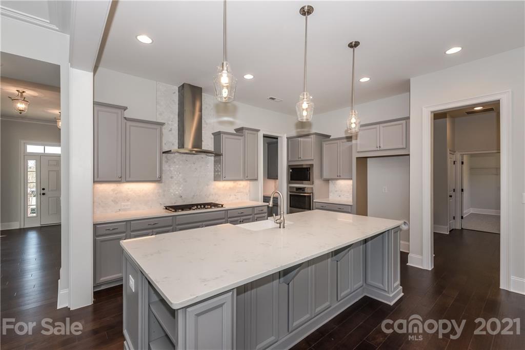 4006 Oarman Court, Unit 440 Fort Mill, SC 29708 - Photo 5 of 15 a kitchen with stainless steel appliances granite countertop a sink a stove and a refrigerator