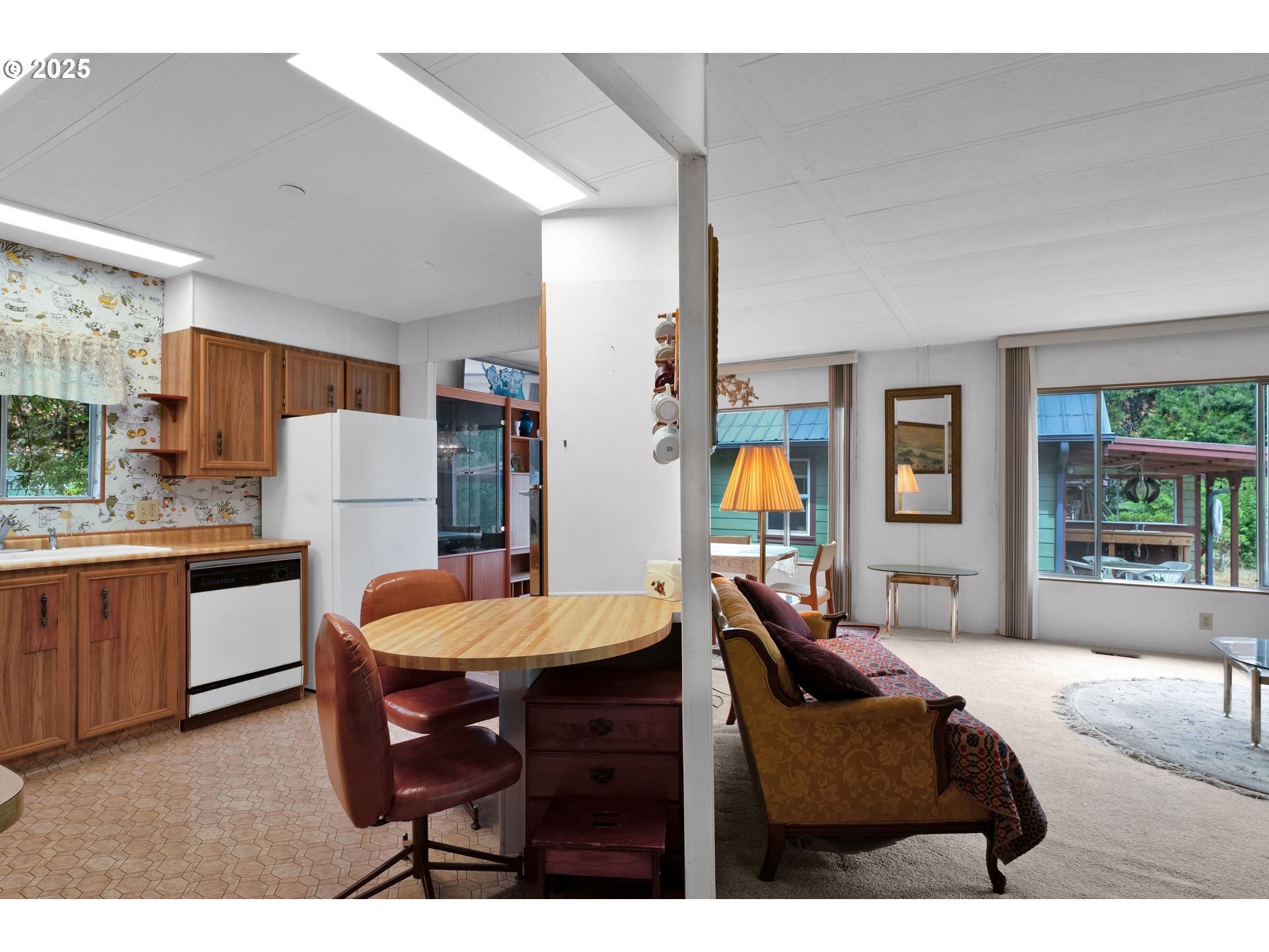 10273 Sweet Creek Road Mapleton, OR 97453 - Photo 16 of 48 a living room with furniture a dining table and kitchen view