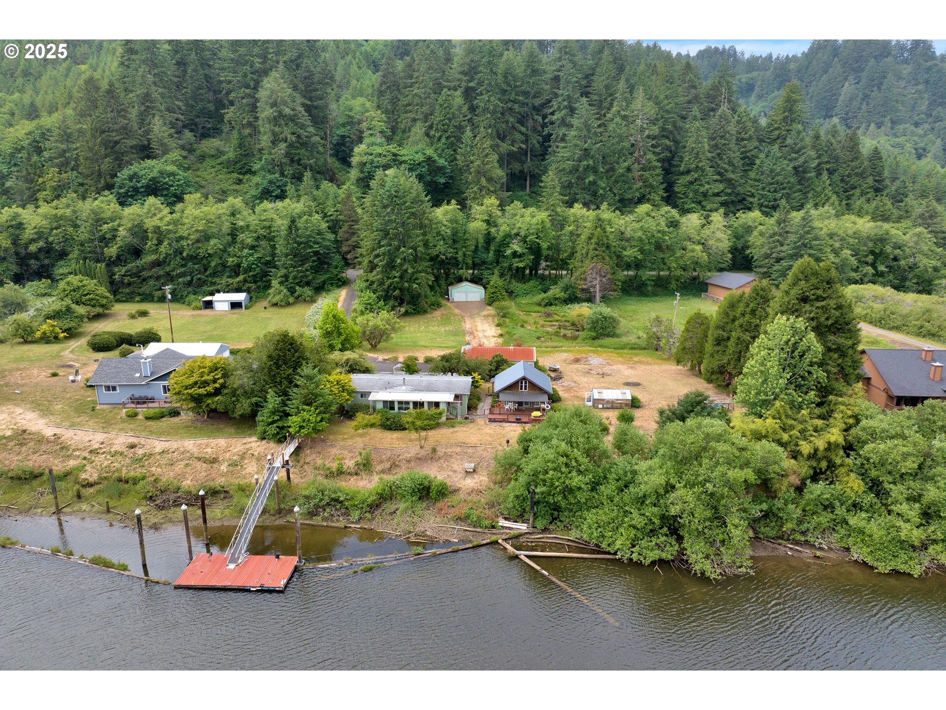 10273 Sweet Creek Road Mapleton, OR 97453 - Photo 44 of 48 a view of a lake with a yard and mountain