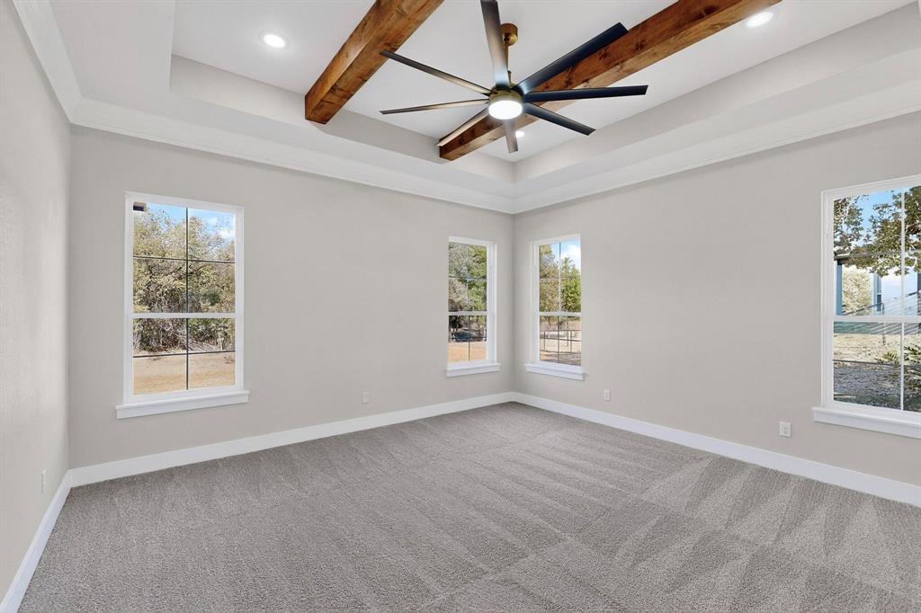 1161 Gonzollas Road Springtown, TX 76082 - Photo 24 of 40 an empty room with windows and fan