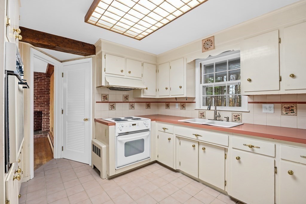 1 Maynard Street Northborough, MA 01532 - Photo 12 of 41 a kitchen with stainless steel appliances granite countertop a sink and cabinets