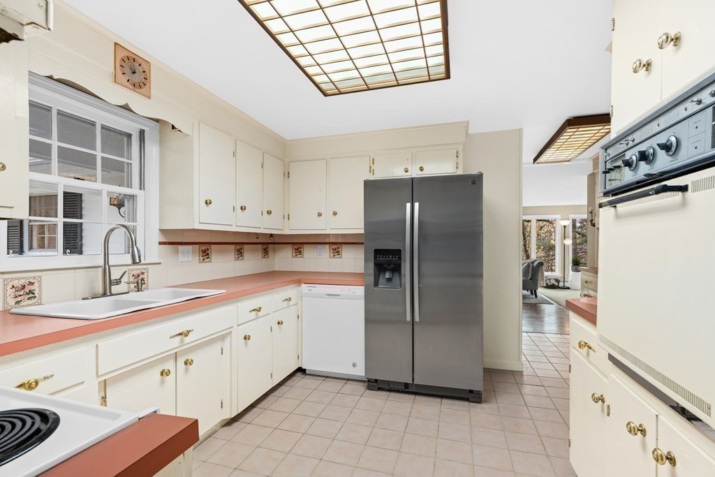 1 Maynard Street Northborough, MA 01532 - Photo 13 of 41 a kitchen with stainless steel appliances a refrigerator sink and cabinets