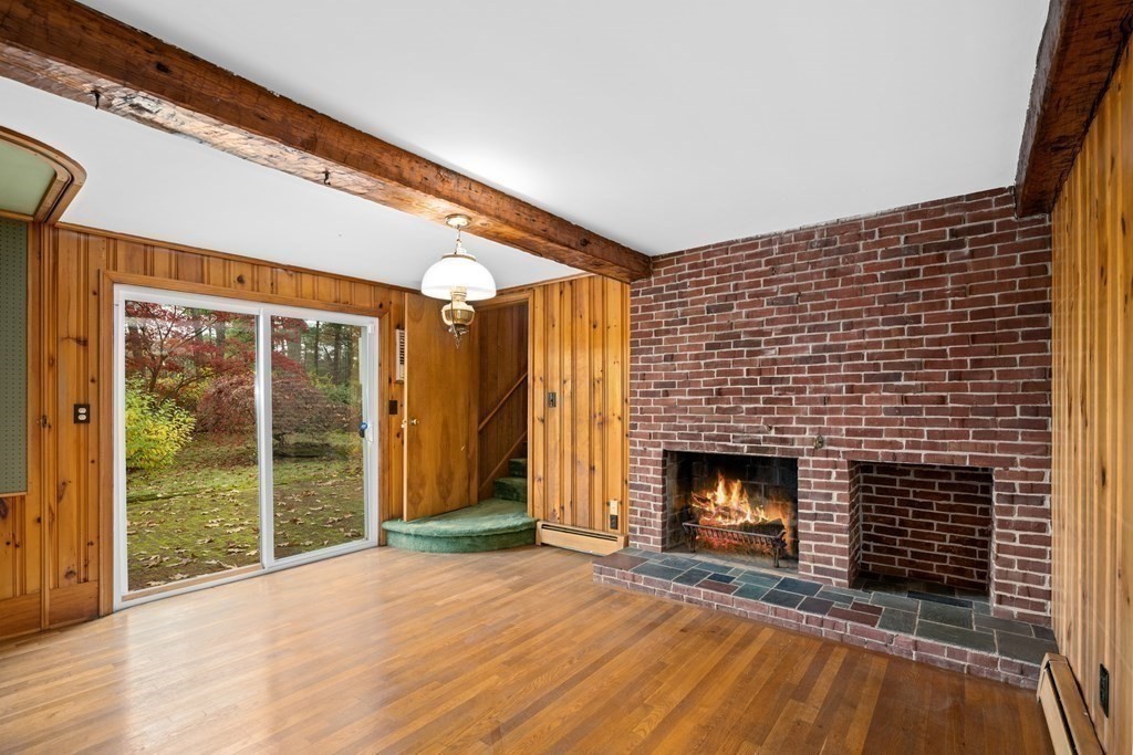 1 Maynard Street Northborough, MA 01532 - Photo 10 of 41 a view of empty room with wooden floor and fireplace