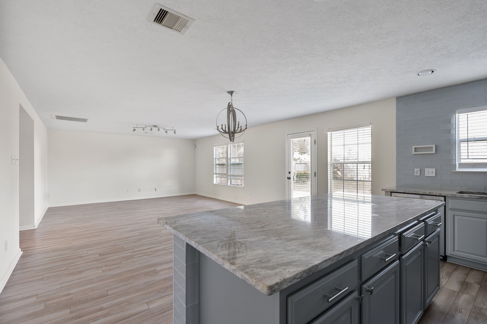 18102 Clayton Bluff Lane Cypress, TX 77433 - Photo 14 of 30 a open kitchen with granite countertop a sink and dishwasher with wooden floor