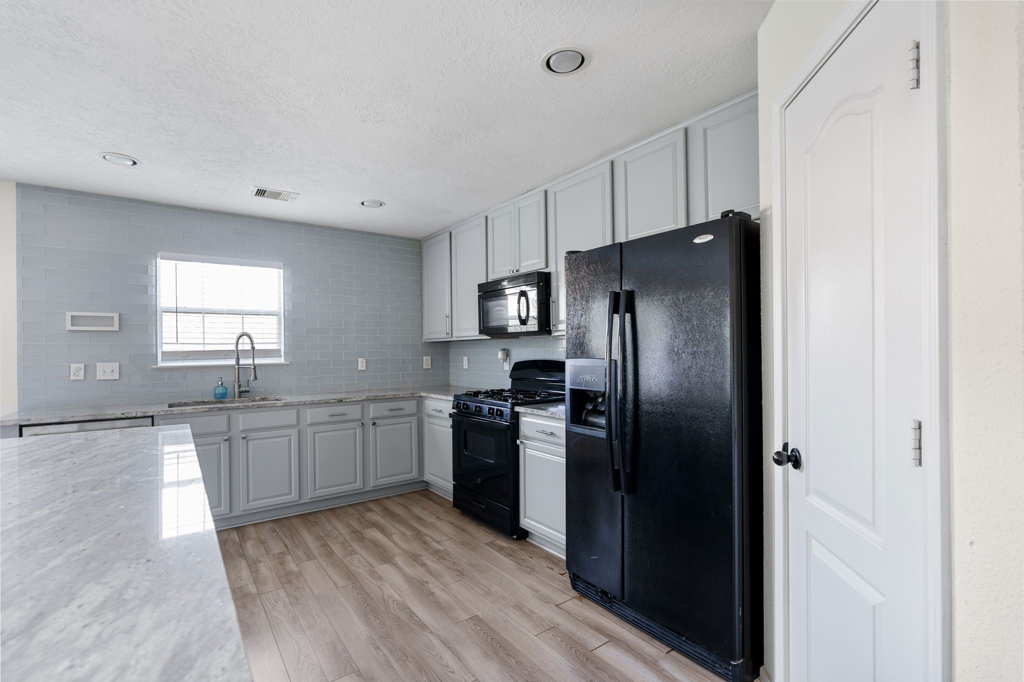 18102 Clayton Bluff Lane Cypress, TX 77433 - Photo 15 of 30 a kitchen with stainless steel appliances granite countertop a refrigerator and a sink