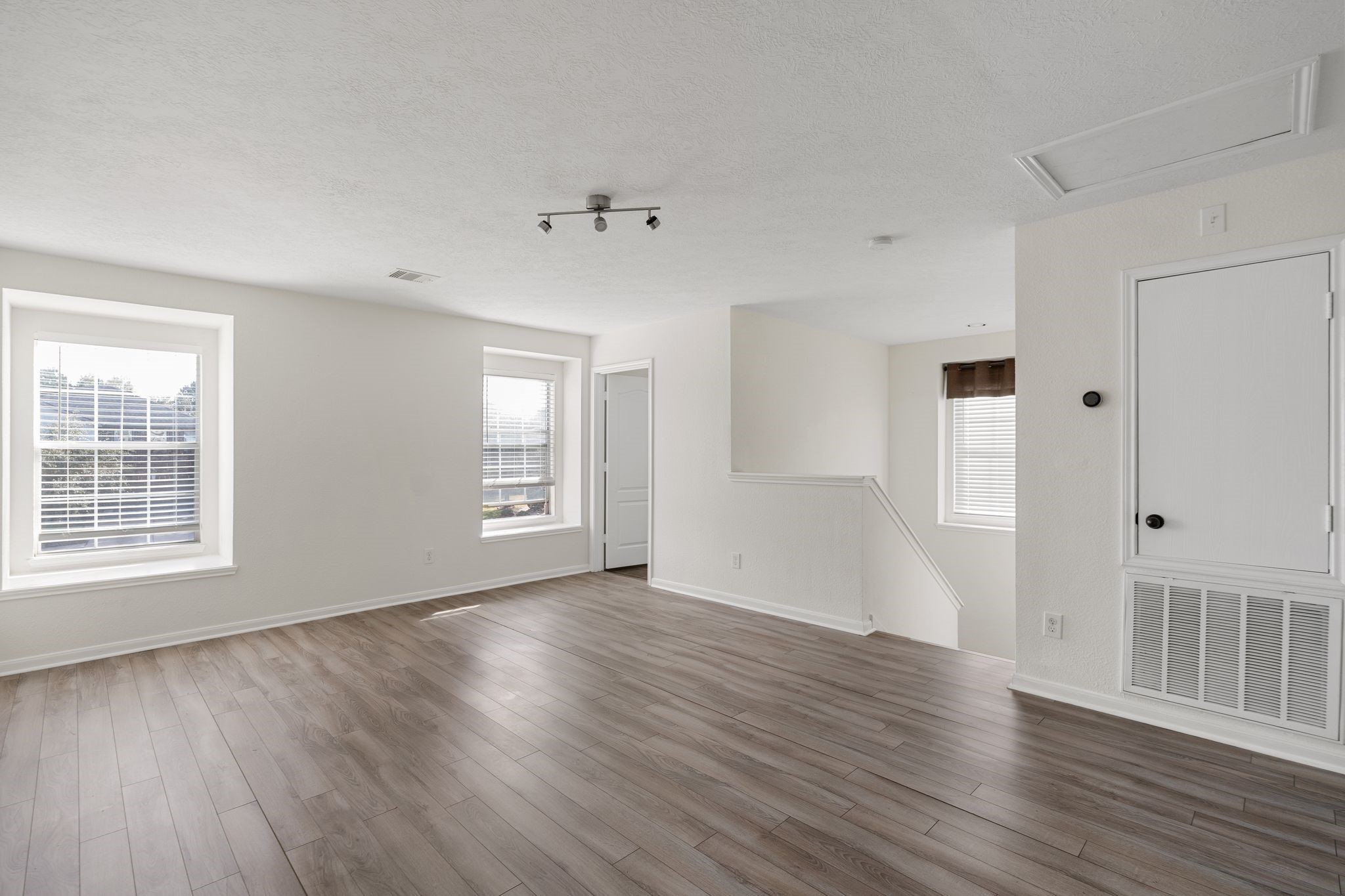 18102 Clayton Bluff Lane Cypress, TX 77433 - Photo 18 of 30 a view of an empty room with wooden floor and a window