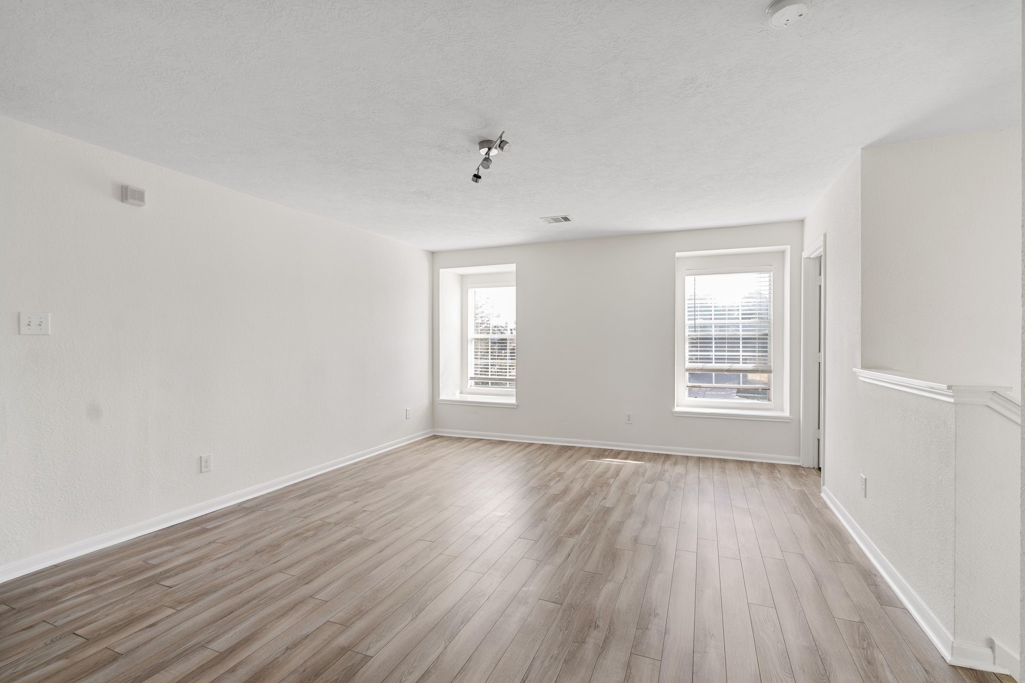 18102 Clayton Bluff Lane Cypress, TX 77433 - Photo 19 of 30 an empty room with wooden floor and windows