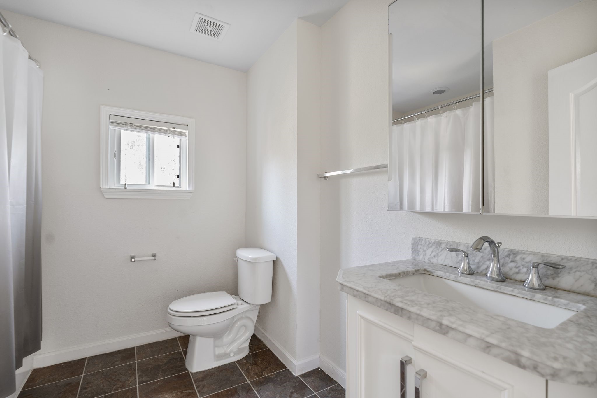 18102 Clayton Bluff Lane Cypress, TX 77433 - Photo 26 of 30 a bathroom with a granite countertop toilet a sink and a mirror