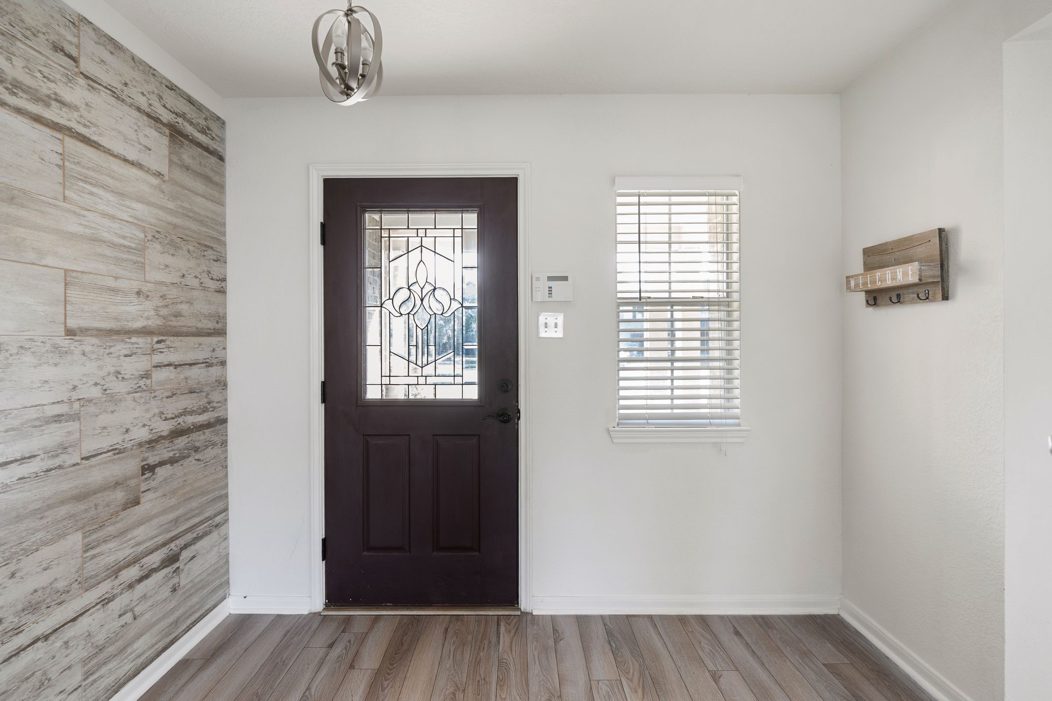 18102 Clayton Bluff Lane Cypress, TX 77433 - Photo 4 of 30 a view of an empty room with wooden floor and a window