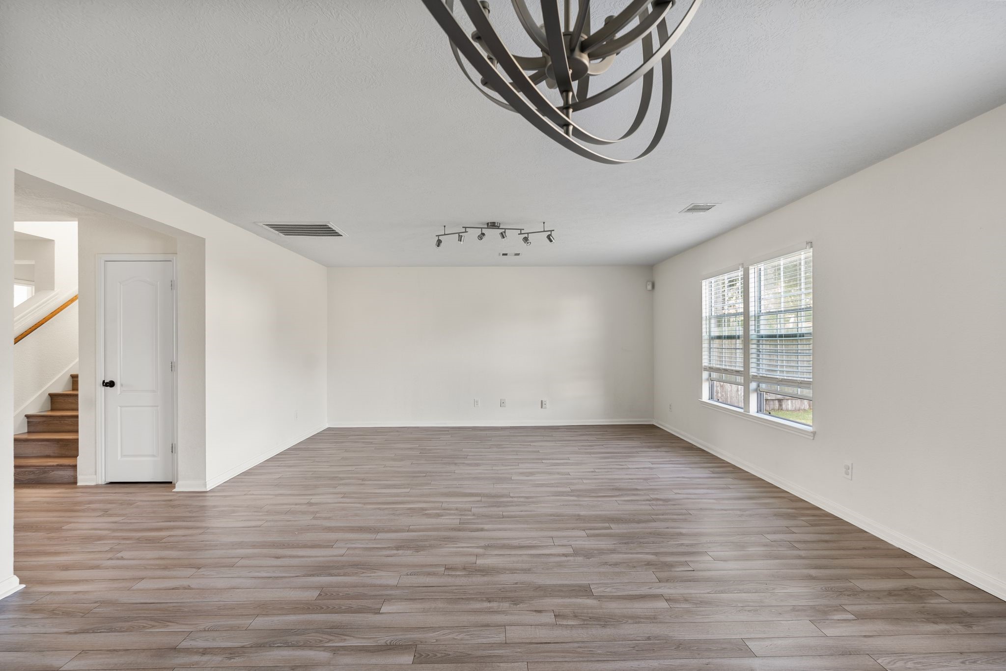 18102 Clayton Bluff Lane Cypress, TX 77433 - Photo 7 of 30 a view of an empty room with wooden floor and window