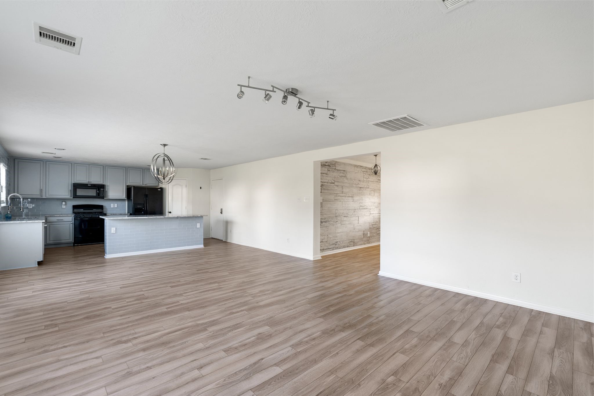 18102 Clayton Bluff Lane Cypress, TX 77433 - Photo 8 of 30 a view of a kitchen with wooden floor and a sink