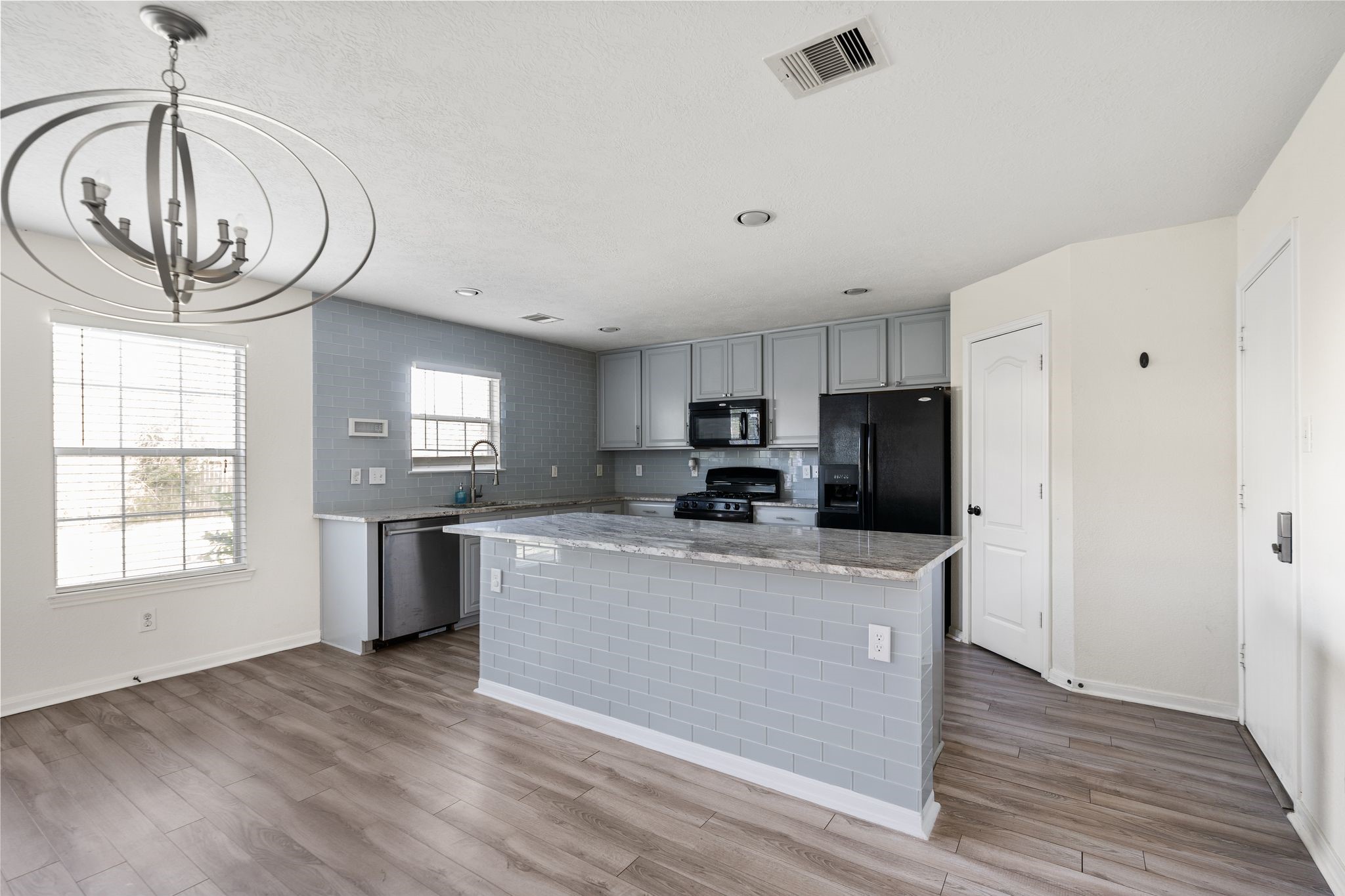 18102 Clayton Bluff Lane Cypress, TX 77433 - Photo 10 of 30 a kitchen with stainless steel appliances granite countertop a refrigerator a stove and a wooden floors