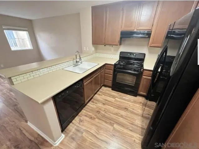 a kitchen with a sink stove and cabinets