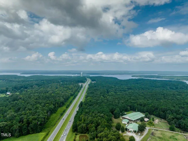 a view of a pathway both side of grassy field with shrub
