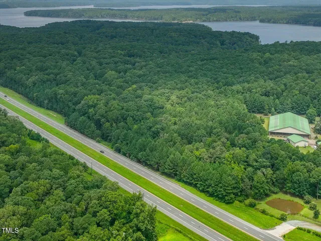 a view of a yard with wooden fence
