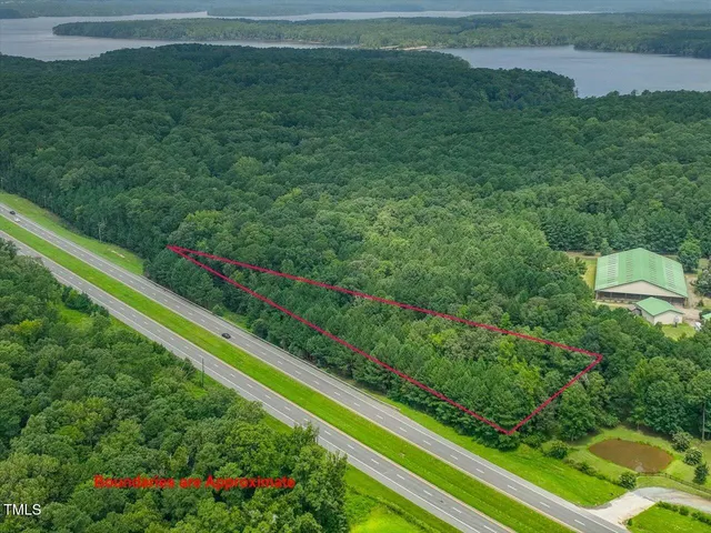 a view of a yard with wooden fence