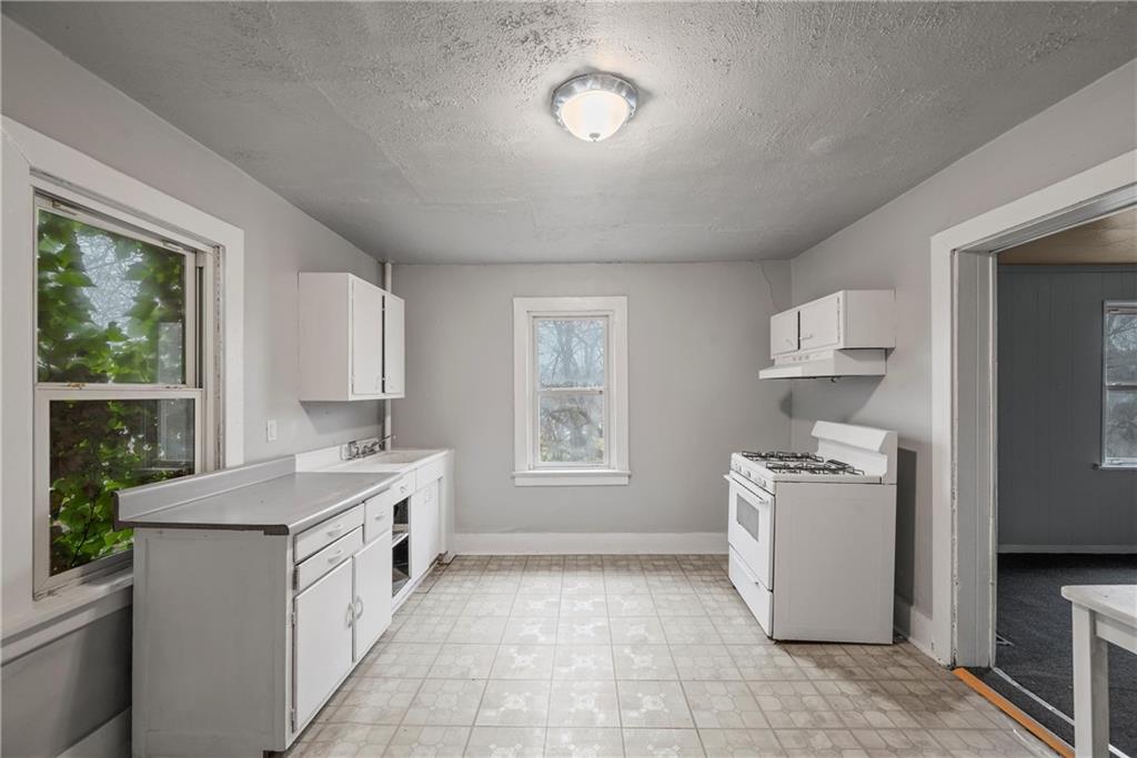 214 Grape Way Clairton, PA 15025 - Photo 7 of 13 a kitchen with a stove a sink and a refrigerator