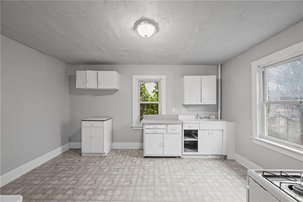 214 Grape Way Clairton, PA 15025 - Photo 8 of 13 a room with a white cabinets and window