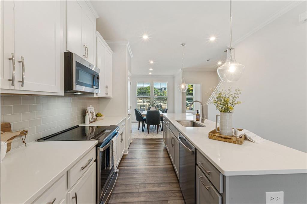 1201 Skylar Lane Southeast Atlanta, GA 30315 - Photo 11 of 37 a kitchen with counter top space a sink appliances and cabinets