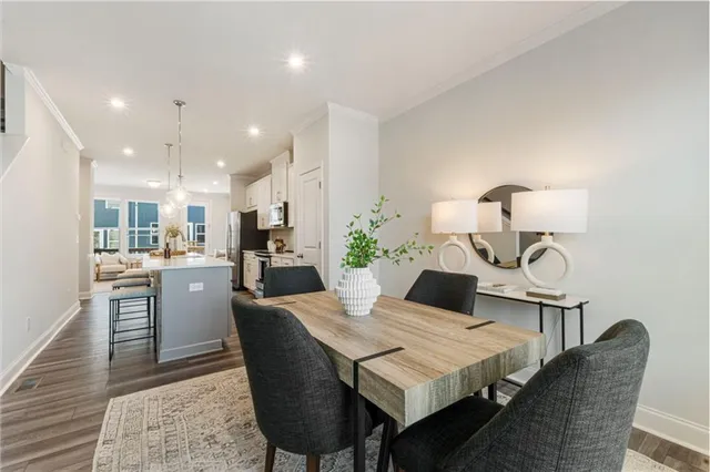 a dining room with kitchen island a table and chairs