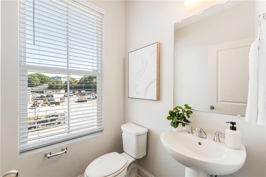 1201 Skylar Lane Southeast Atlanta, GA 30315 - Photo 14 of 37 a bathroom with a sink a toilet and a window