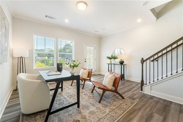 a living room with furniture a window and a potted plant