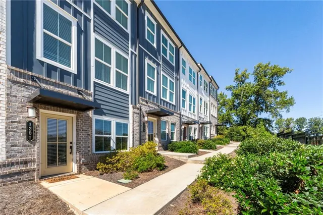 a front view of a house with a garden