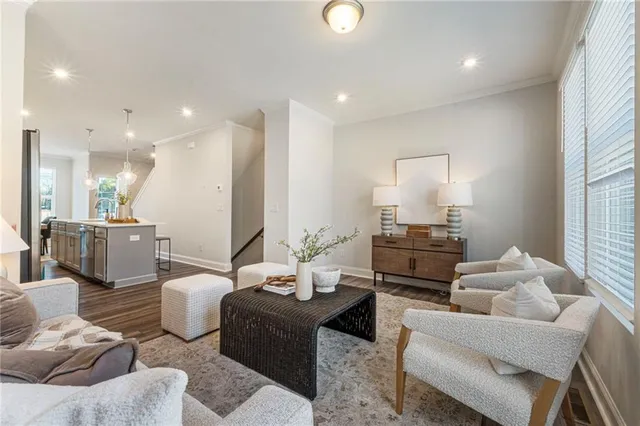 a living room with furniture a mirror and a lamp