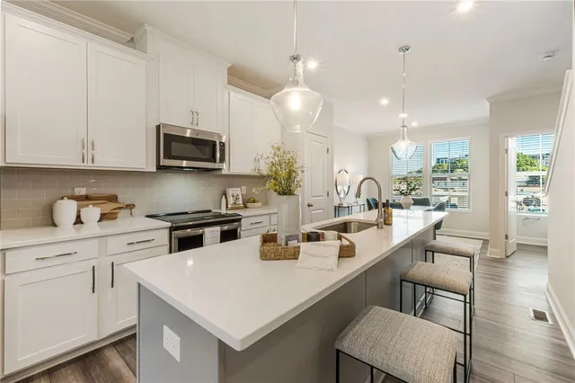 a kitchen with a sink a stove and cabinets