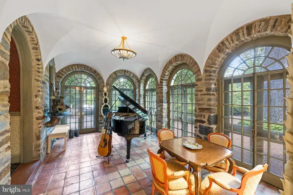 a living room with furniture a table and a fireplace