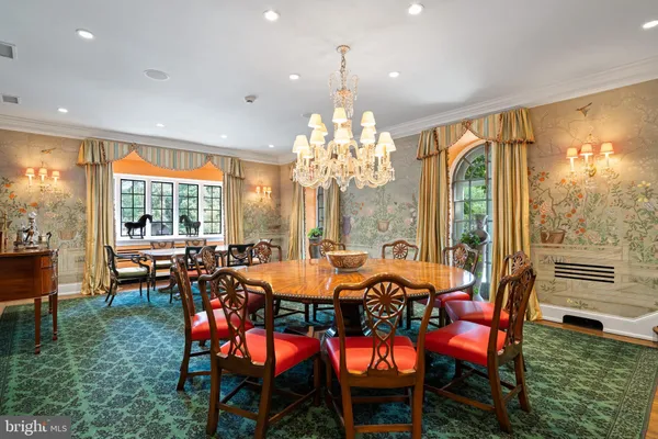 a view of a dining room and kitchen with a table chairs